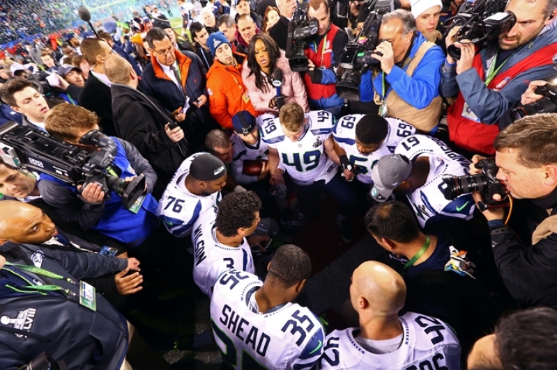 Seattle Seahawks Russell Wilson and Christian Teammates kneel prayer Super Bowl XLVIII win