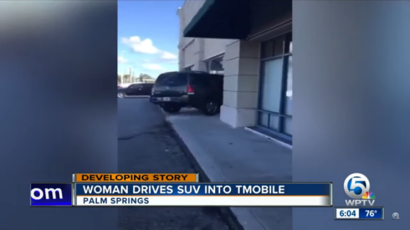 Upset lady drives her SUV into a T-Mobile store.