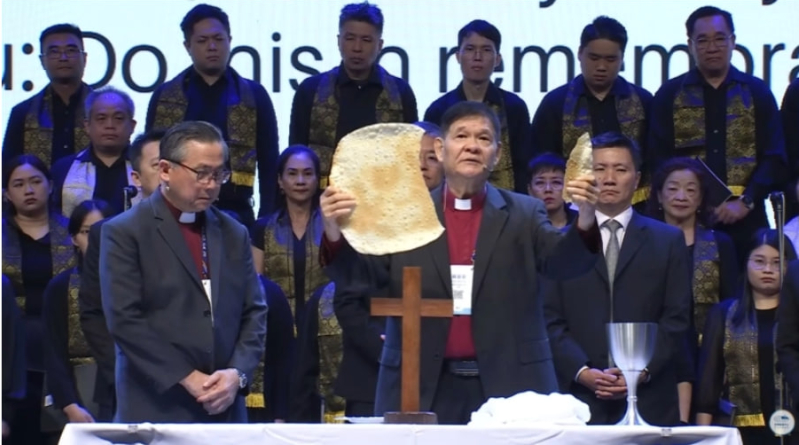The Rev. Su Chii Ann presides over Holy Communion at the closing ceremony on July 24